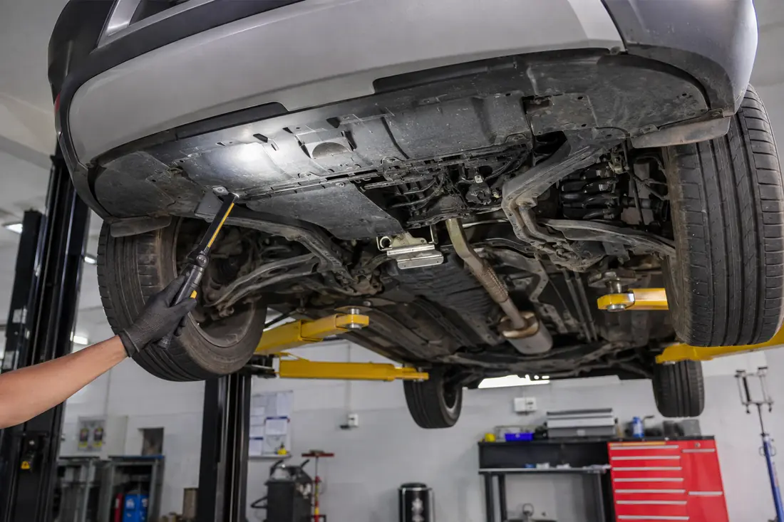 Vehicle underbody being viewed with inspection lighting on a lift