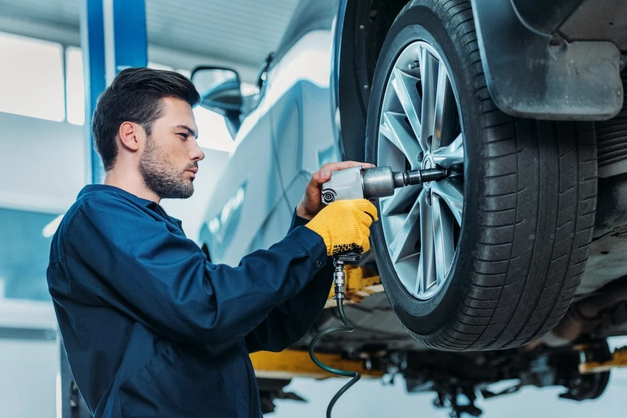 Mechanic preparing a wheel for detailed tire inspection